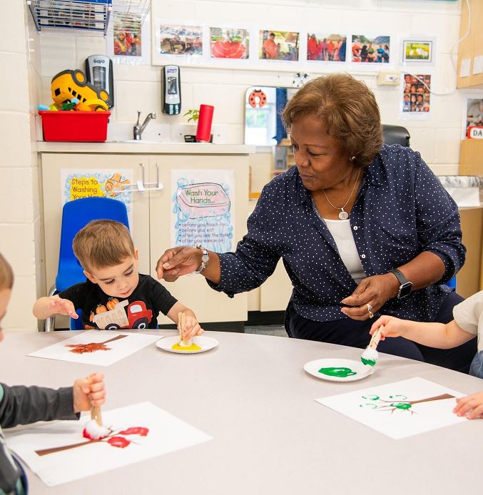 Congressional School toddler painting with their teacher Congressional School toddler painting with their teacher